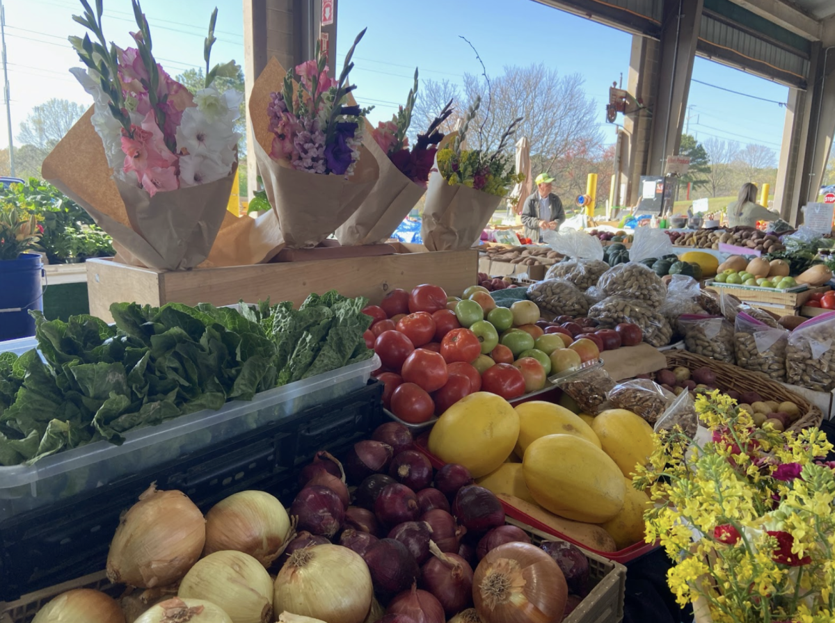 Fresh produce and flowers being sold on a sunny Saturday afternoon at the North Carolina State Farmers Market.